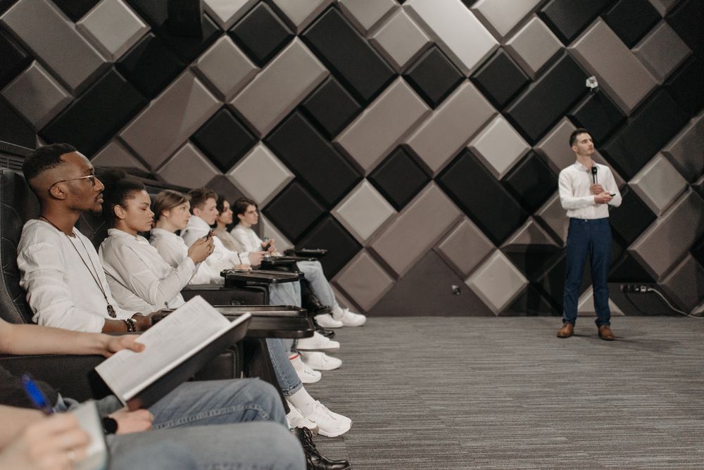 Classroom participants listening to an instructor